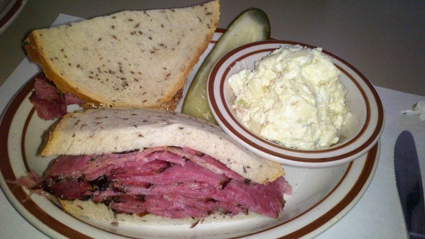 Pastrami sandwich on rye with potato salad