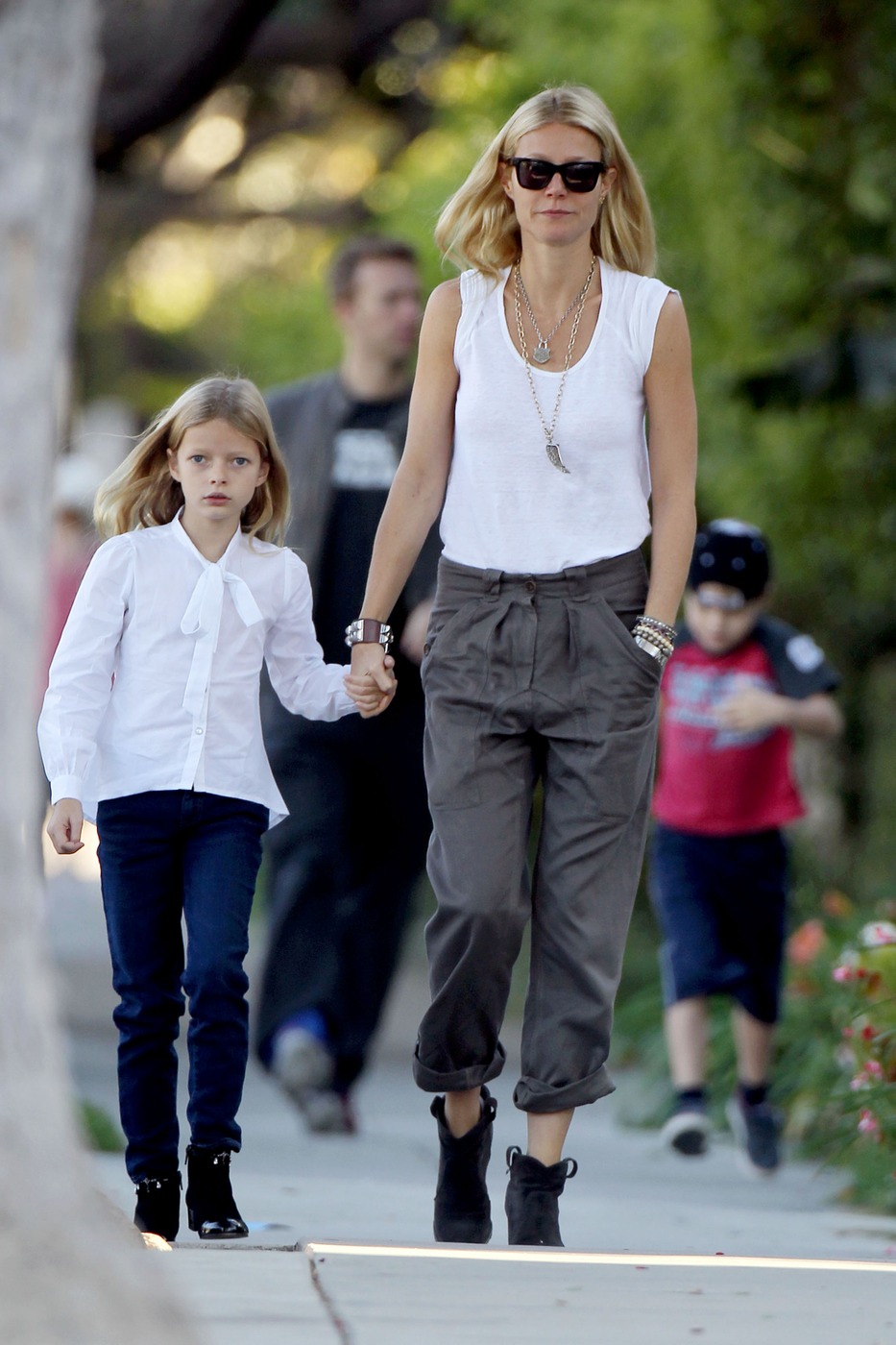 Gwyneth Paltrow and Chris Martin take their children Moses and Apple to school in Los Angeles