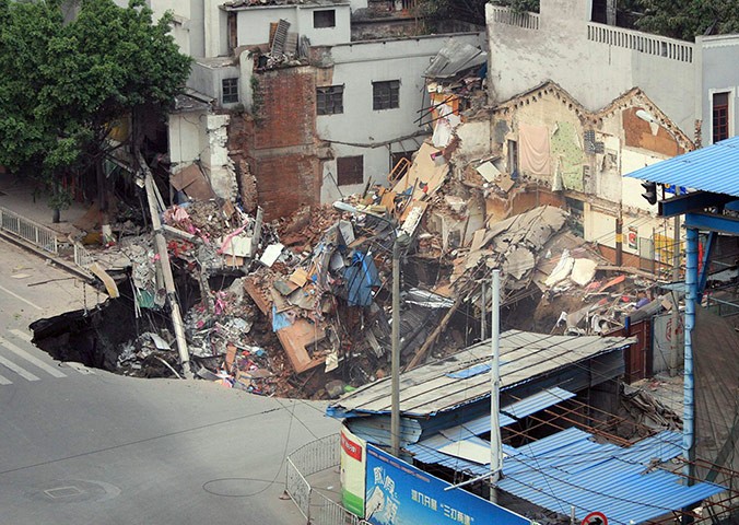 A sinkhole with buildings collapsed inside