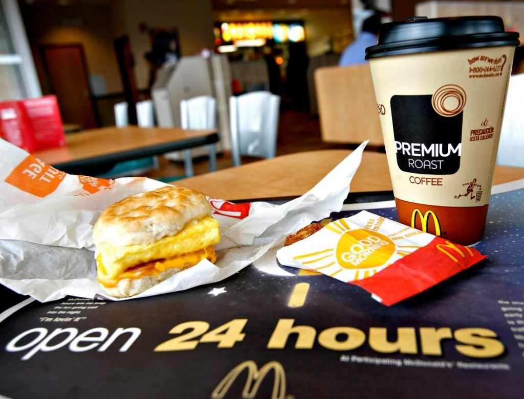 A sausage Egg McMuffin meal with hash browns and Premium Roa