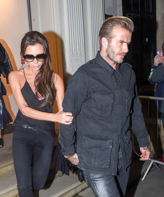 ***MANDATORY BYLINE TO READ INFPhoto.com ONLY*** Victoria Beckham looks worse for wear as she leaves a special dinner to celebrate the first year anniversary of her London flagship store during London Fashion Week. The designer appeared to have a large wet patch on the crotch of her black pants as she hung onto the arm of husband David David as she left the Dover street store.  Pictured: Victoria Beckham, David Beckham Ref: SPL1134893  230915   Picture by: INFphoto.com 