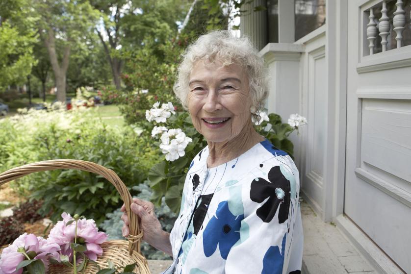 Beautiful 86 year old woman with basket of flowers