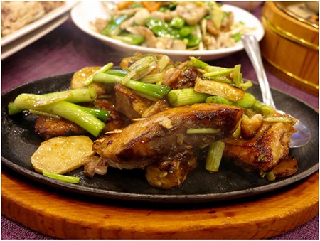 Pan Fried Fish Belly with soy sauce on sizzling hot plate