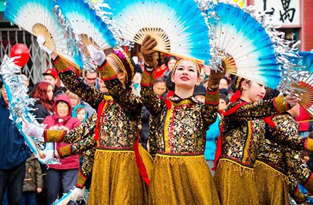 VANCOUVER, CANADA - FEBRUARY 17 2013: Group of young women perform in national costumes with fans. Chinese Lunar New Year parade on February 17, 2013 in Vancouver, BC; Shutterstock ID 250267459; Project/Title: World's Biggest Chinese New Year Celebrations; Downloader: Fodor's Travel