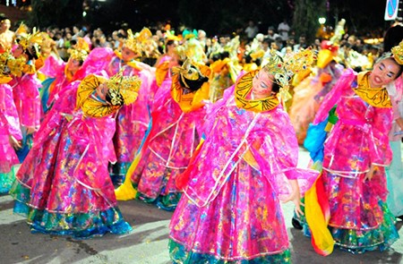 Female chinese dancers in bright and gaudy robes and elaborate headgear dancing during the 2009 Singapore Chingay Parade held in the city on the 30 Jan 2009.